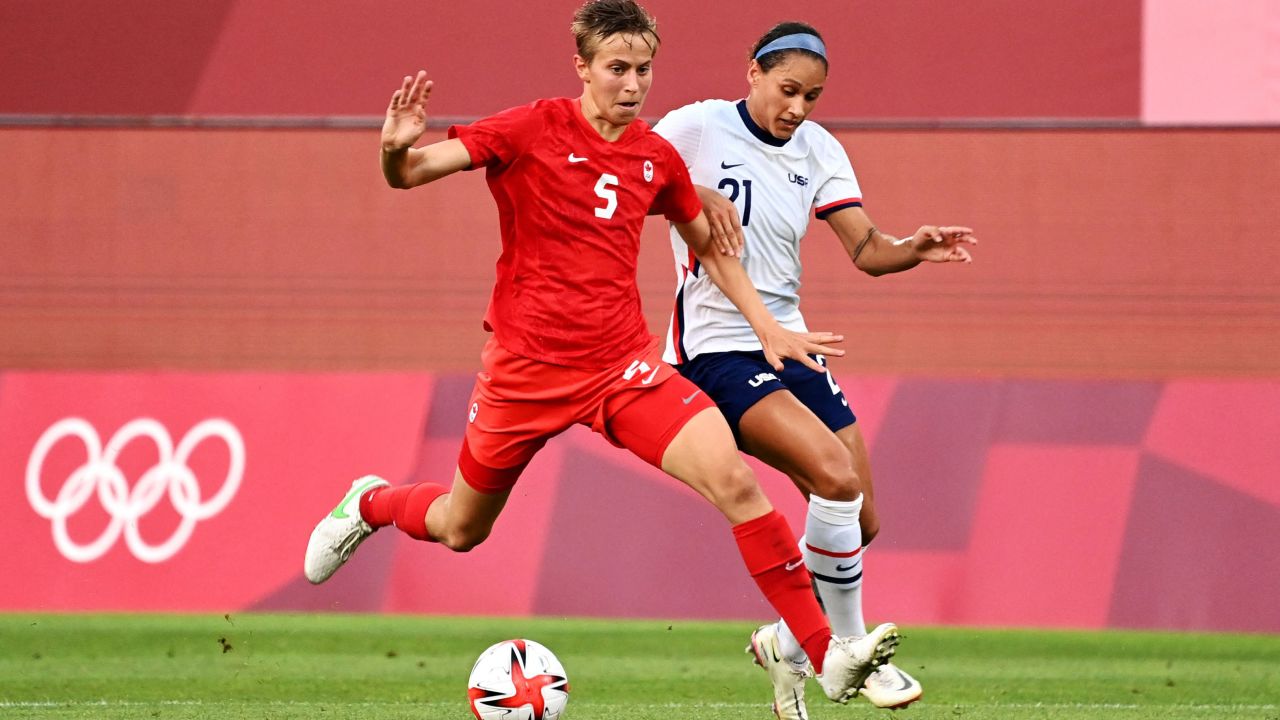 Canada's midfielder Quinn is marked by USA forward Lynn Williams (R) during the Olympic semi match.