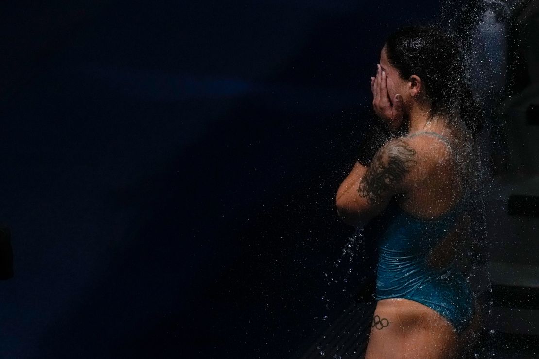 Ingrid Oliveira of Brazil takes a shower after competing in women's diving 10-meter platform preliminary at the Tokyo Olympics on August 4.