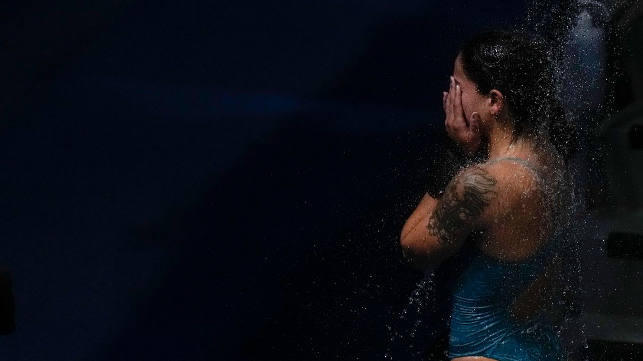 Ingrid Oliveira of Brazil takes a shower after competing in women's diving 10-meter platform preliminary at the Tokyo Olympics on August 4.