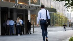 An office worker walks toward the Goldman Sachs Group Inc. headquarters in New York, U.S., on Thursday, July 22, 2021. After a year of Zoom meetings and awkward virtual happy hours, New York's youngest aspiring financiers have returned to the offices of the city's investment banks, where they're making the most of the in-person mentoring and networking they've lacked during the pandemic. Photographer: Michael Nagle/Bloomberg via Getty Images