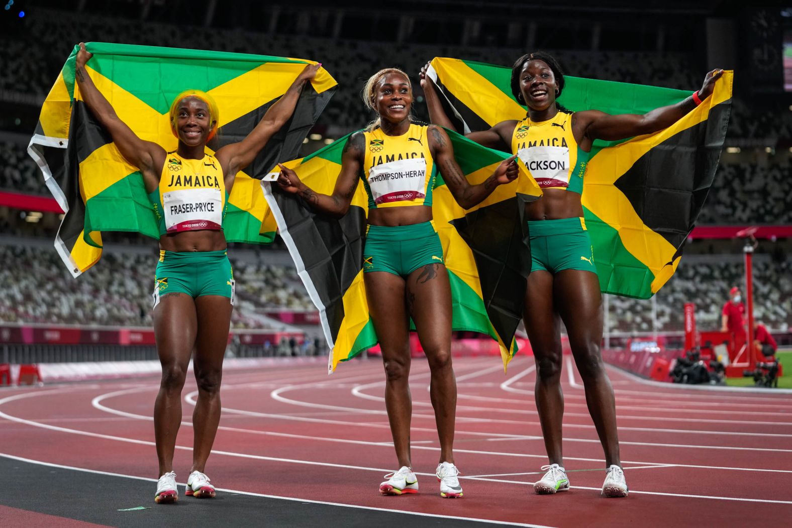 From left, Jamaican sprinters Shelly-Ann Fraser-Pryce, Elaine Thompson-Herah and Shericka Jackson celebrate after <a href="index.php?page=&url=https%3A%2F%2Fwww.cnn.com%2Fworld%2Flive-news%2Ftokyo-2020-olympics-07-31-21-spt%2Fh_fad429aba3c7d06c0e4de7fd7b3973ba" target="_blank">sweeping the 100 meters</a> on July 31. Thompson-Herah won gold and was followed by Fraser-Pryce and Jackson.