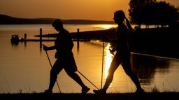 21 September 2020, Bavaria, Allmannsdorf: Two women walk in the evening sun on the dam of Lake Brombach with Nordic Walking sticks. Photo: Daniel Karmann/dpa (Photo by Daniel Karmann/picture alliance via Getty Images)