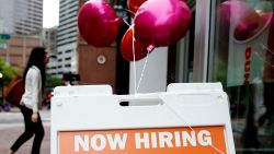 A help wanted sign is posted outside of Dunkin Donuts in Downtown Crossing in Boston on June 14, 2021.