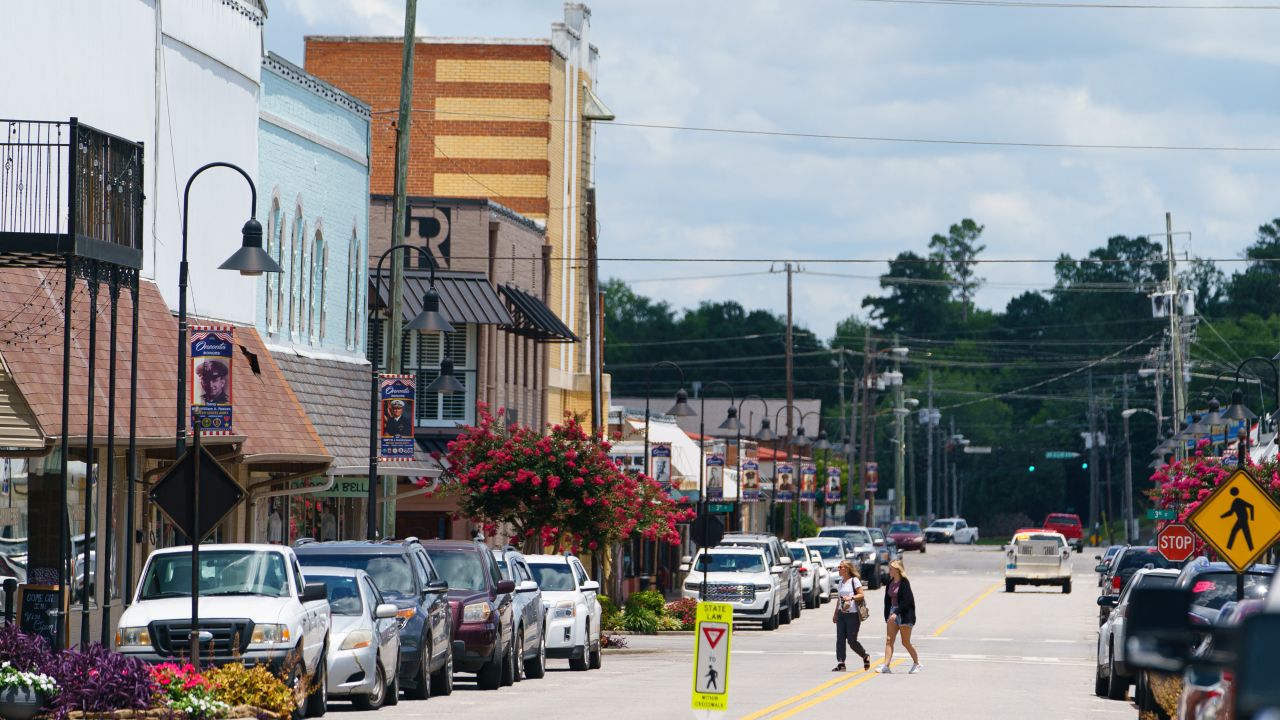 Two women walk across a street in downtown Oneonta on June 30, 2021, in Oneonta, Alabama.
