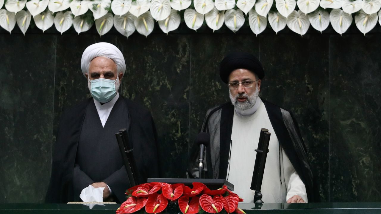 Raisi, right, takes his oath as president in Thursday's ceremony. 