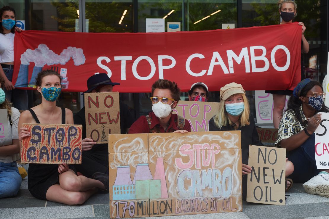 Cambo oilfield protestors rally outside a UK government building in Edinburgh, Scotland on July 19, 2021. 