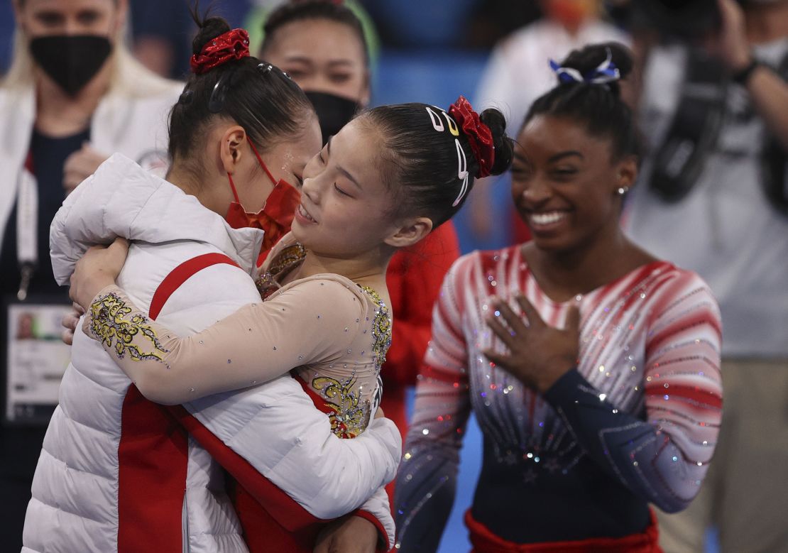 Chinese gymnasts Tang Xijing and Guan Chenchen, and US gymnast Simone Biles celebrate after the women's balance beam final at the Tokyo Olympics on August 3.