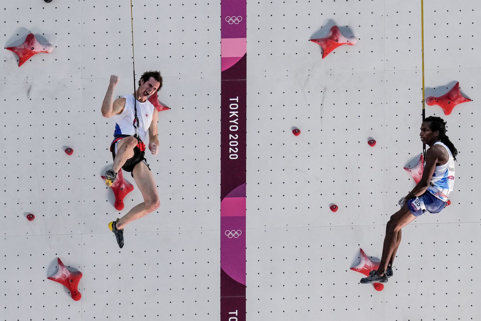 The Czech Republic's Adam Ondra, left, celebrates after he defeated France's Mickael Mawem in the sport climbing speed finals on August 5.