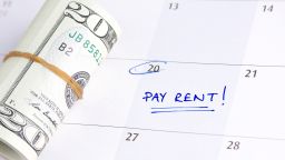 underscored pay rent due date on calendar with cash