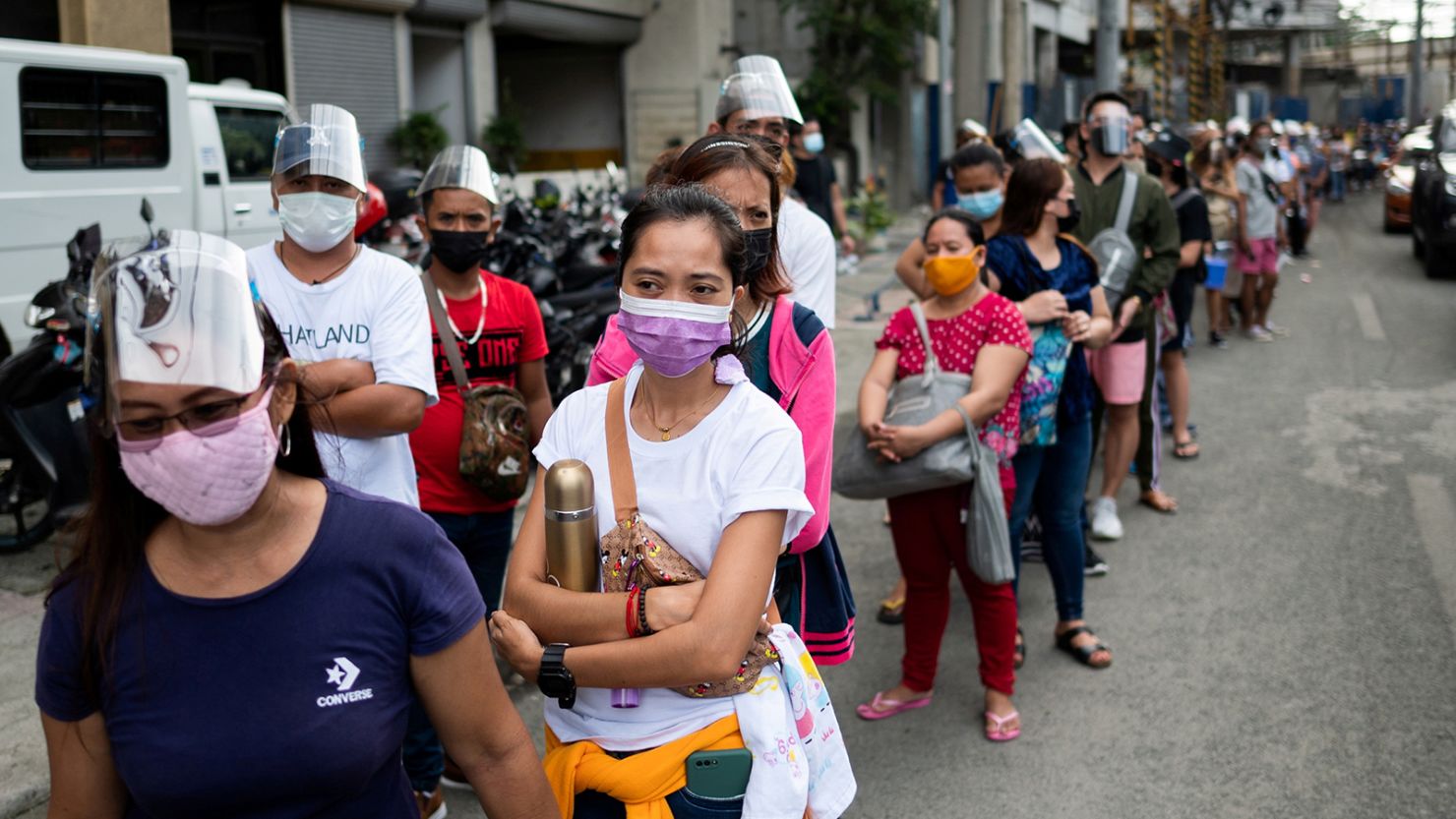 Filipinos waiting to be vaccinated against Covid-19 line up outside a mall in Manila on August 5.