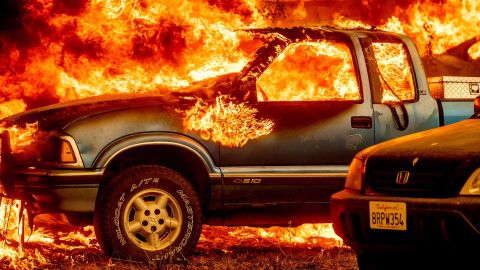 Flames from the Dixie Fire consume a pickup truck on Highway 89, south of Greenville, California, on Thursday, August 5.