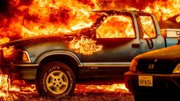 Flames from the Dixie Fire consume a pickup truck on Highway 89 south of Greenville on Thursday, Aug. 5, 2021, in Plumas County, Calif. (AP Photo/Noah Berger)