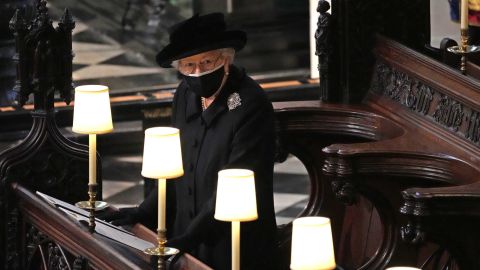 Queen Elizabeth II watches as pallbearers carry Prince Philip's coffin into St. George's Chapel on April 17, 2021.