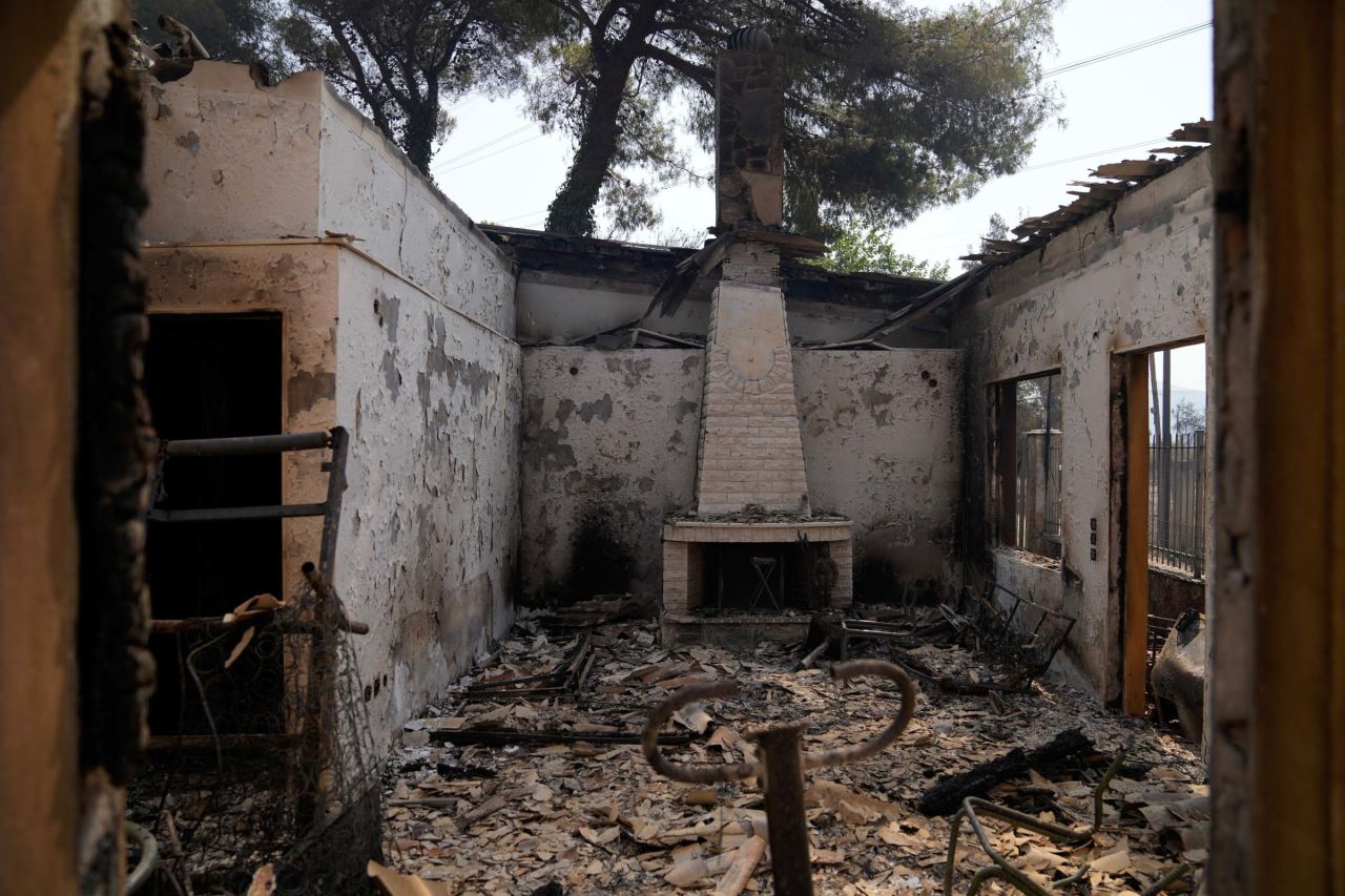 The remnants of a destroyed house are seen in the Varibobi area of northern Athens on August 4.