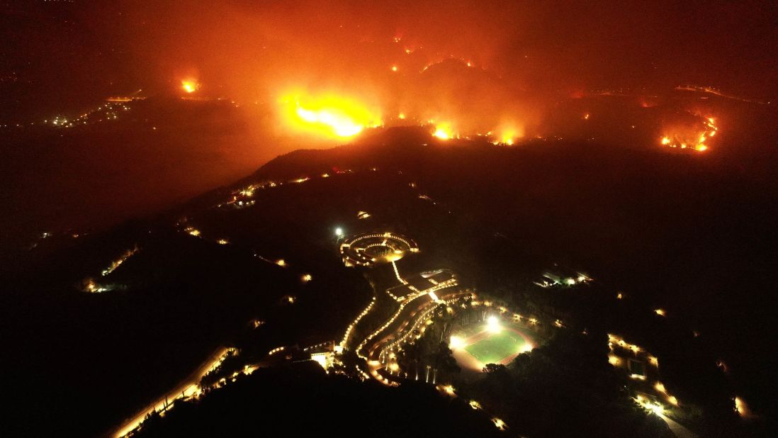 A wildfire approaches the Olympic Academy in Olympia, Greece, on August 4.