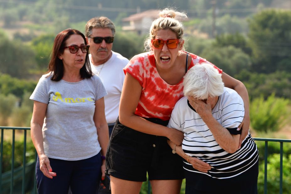 Residents react during a wildfire near Olympia on August 5.