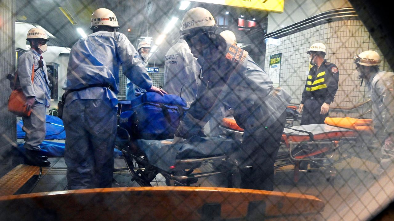 Emergency workers prepare stretchers at Soshigaya Okura Station in Tokyo after a stabbing on a commuter train on Friday left at least 10 people injured. 