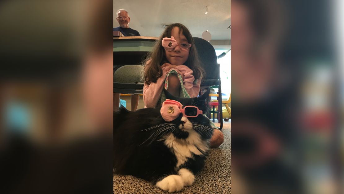 Marin, a patient with amblyopia, and Truffles wear matching eye patches.