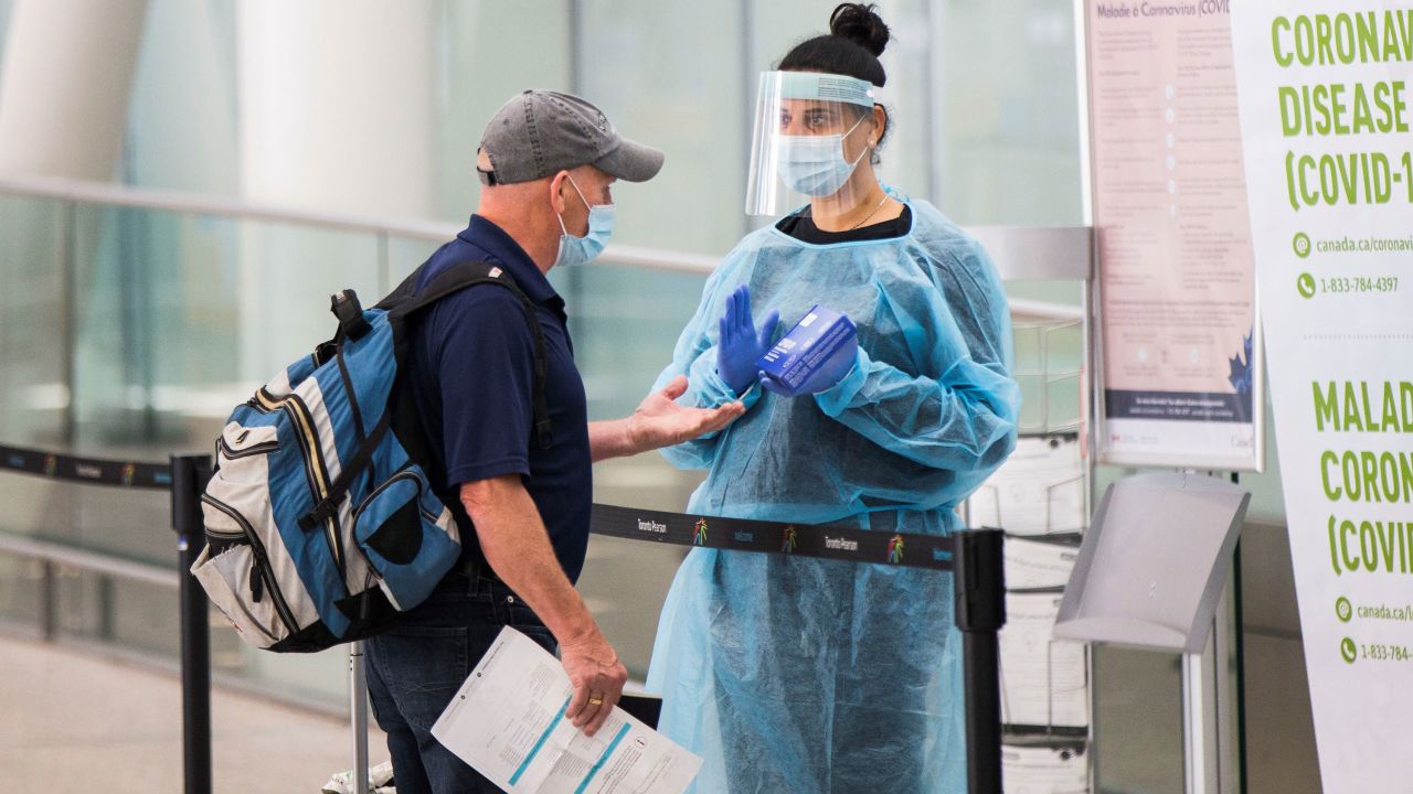 A traveler picks up a Covid-19 at-home collection kit at Toronto Pearson International Airport on July 5, 2021.