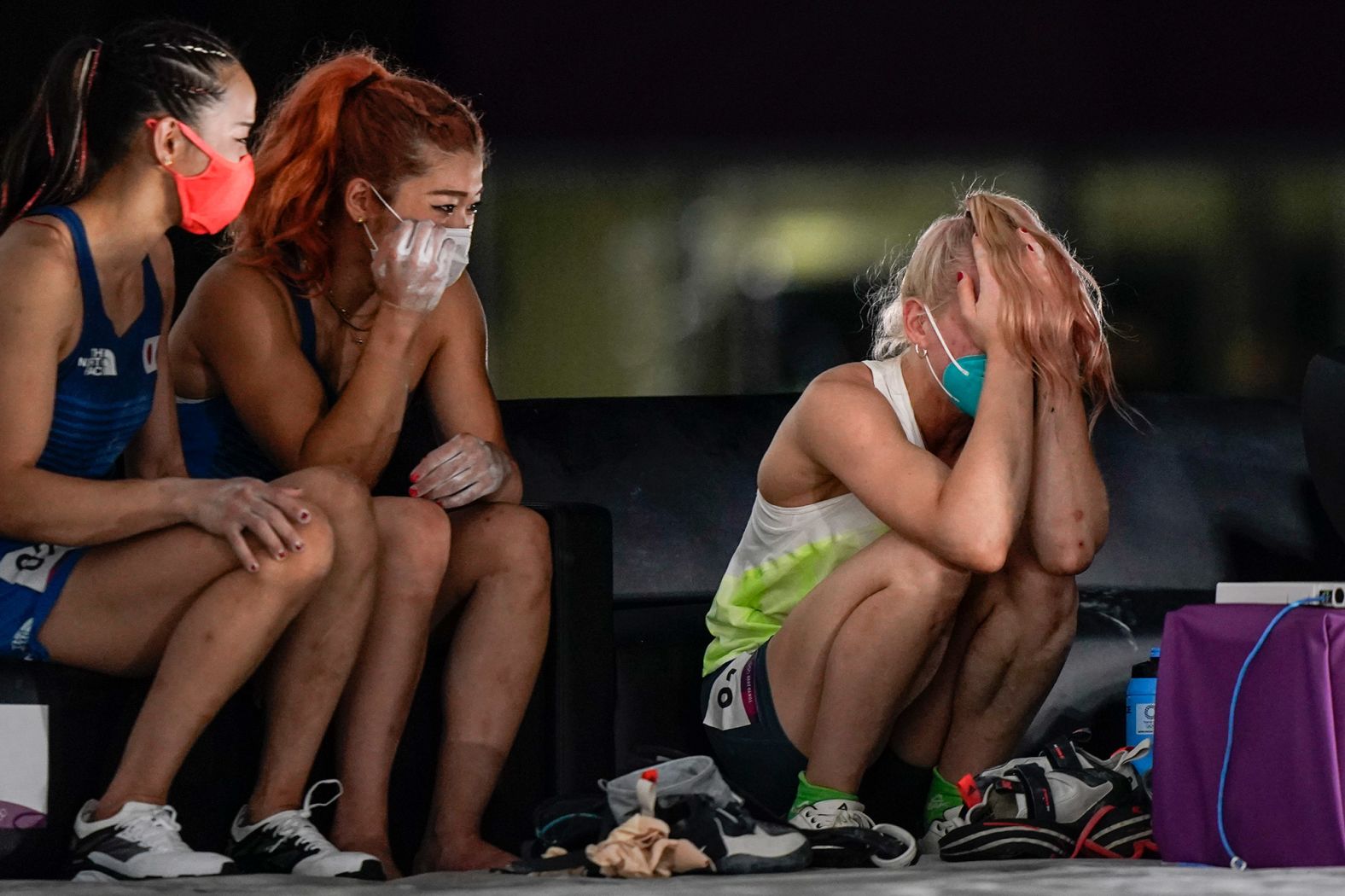 Slovenia's Janja Garnbret reacts after becoming <a href="index.php?page=&url=https%3A%2F%2Fwww.cnn.com%2F2021%2F08%2F06%2Fsport%2Fjanja-garnbret-sports-climbing-tokyo-olympics-spt-intl%2Findex.html" target="_blank">the first woman to win an Olympic gold medal in sport climbing </a>on August 6. At left are bronze medalist Akiyo Noguchi and silver medalist Miho Nonaka, both of Japan.