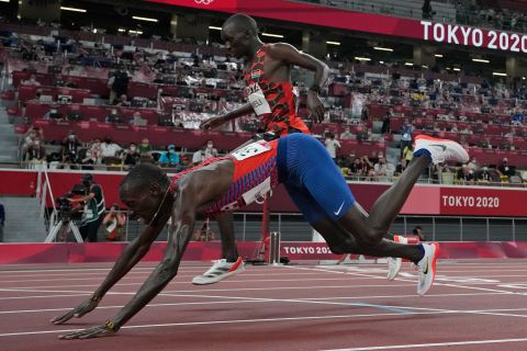 The United States' Paul Chelimo dives over the finish line to win a bronze medal in the 5,000 meters on August 6. He finished just ahead of Kenya's Nicholas Kipkorir Kimeli.