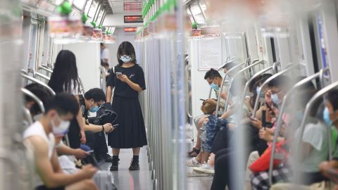 People wear face masks on the subway amid the Delta variant outbreak on July 27 in Nanjing, Jiangsu Province of China. 