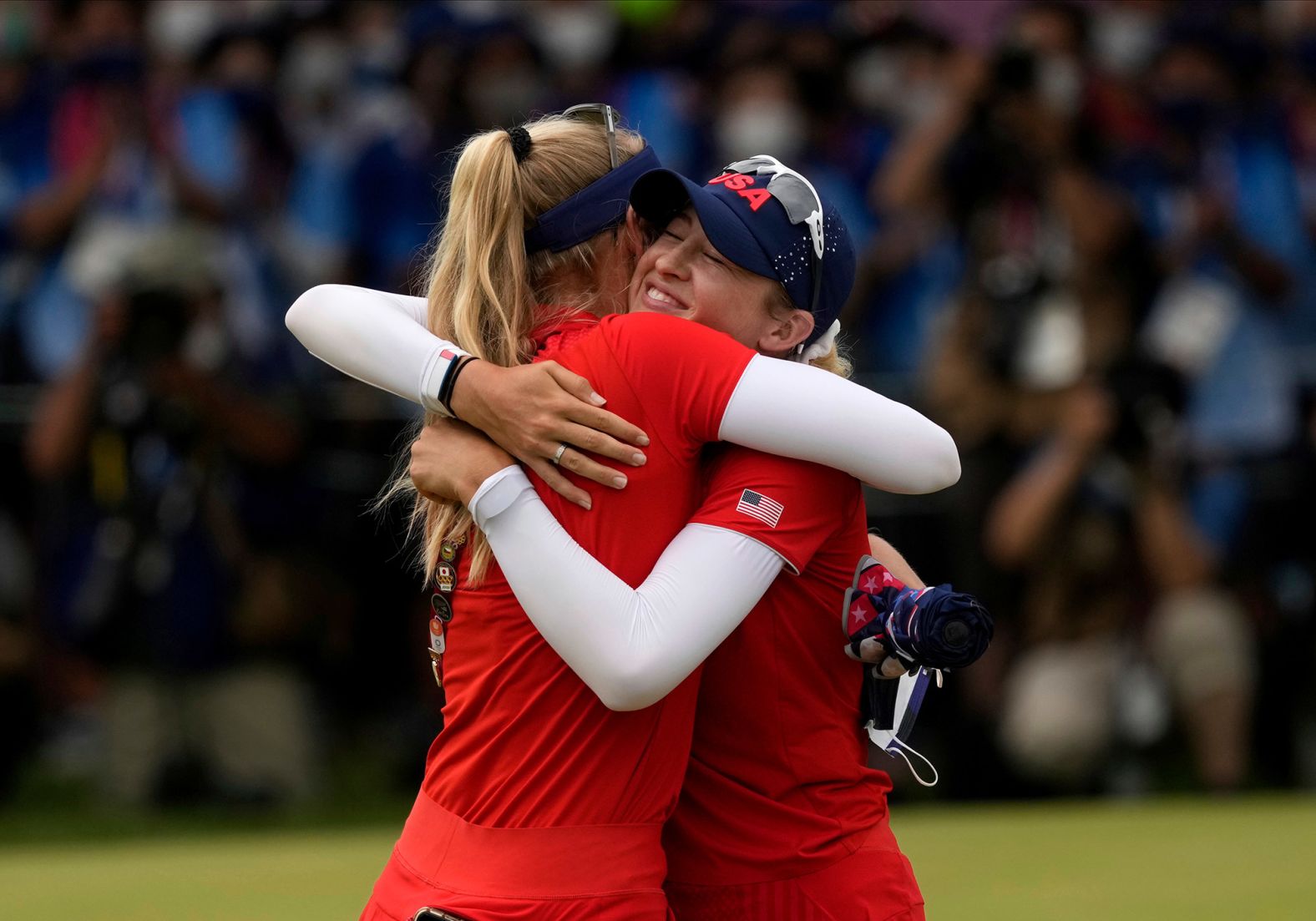 The United States' Nelly Korda, right, is congratulated by her sister, Jessica, after <a href="index.php?page=&url=https%3A%2F%2Fwww.cnn.com%2Fworld%2Flive-news%2Ftokyo-2020-olympics-08-07-21-spt%2Fh_1ef78f509d1f661ba17cbf7cac6844a3" target="_blank">winning the gold medal by one stroke</a> on August 7. Nelly Korda, the world's top-ranked female golfer, took the tournament lead after a second-round 62. Jessica Korda finished tied for 15th.