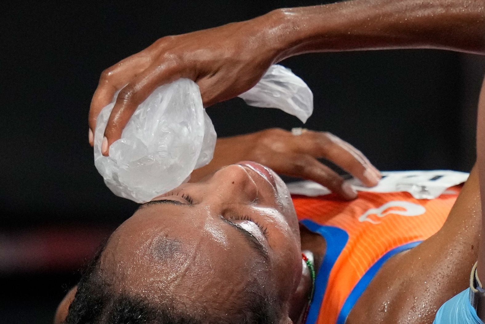 The Netherlands' Sifan Hassan places a bag of ice on her face after <a href="index.php?page=&url=https%3A%2F%2Fwww.cnn.com%2Fworld%2Flive-news%2Ftokyo-2020-olympics-08-07-21-spt%2Fh_c82d5d9a6c216a4f0d275f26f95aaa58" target="_blank">winning gold in the 10,000 meters</a> on August 7. Hassan also won the 5,000 meters in Tokyo and finished third in the 1,500. She's the first person in Olympic history to complete a medley of medals across both the middle- and long-distance events in a single Games.