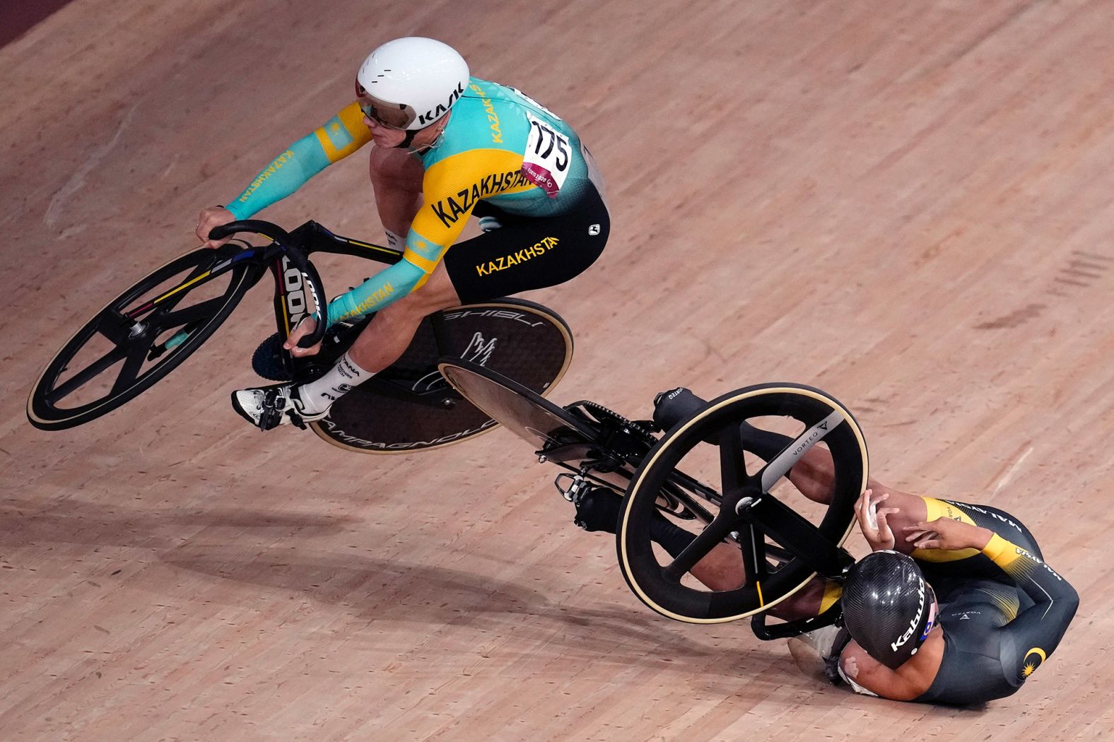 Kazakhstan's Sergey Ponomaryov, left, crashes with Malaysia's Muhammad Shah Firdaus Sahrom during a keirin race on August 7.