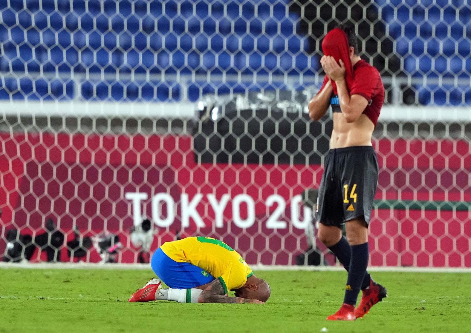 Brazilian defender Dani Alves, left, and Spanish midfielder Carlos Soler react after <a href="index.php?page=&url=https%3A%2F%2Fwww.cnn.com%2Fworld%2Flive-news%2Ftokyo-2020-olympics-08-07-21-spt%2Fh_bbe049a5800eb5f90d4e598956a6dd58" target="_blank">Brazil defeated Spain</a> 2-1 in the gold-medal football match on August 7. Brazil is the fifth men's team in history to win back-to-back titles at the Olympics.
