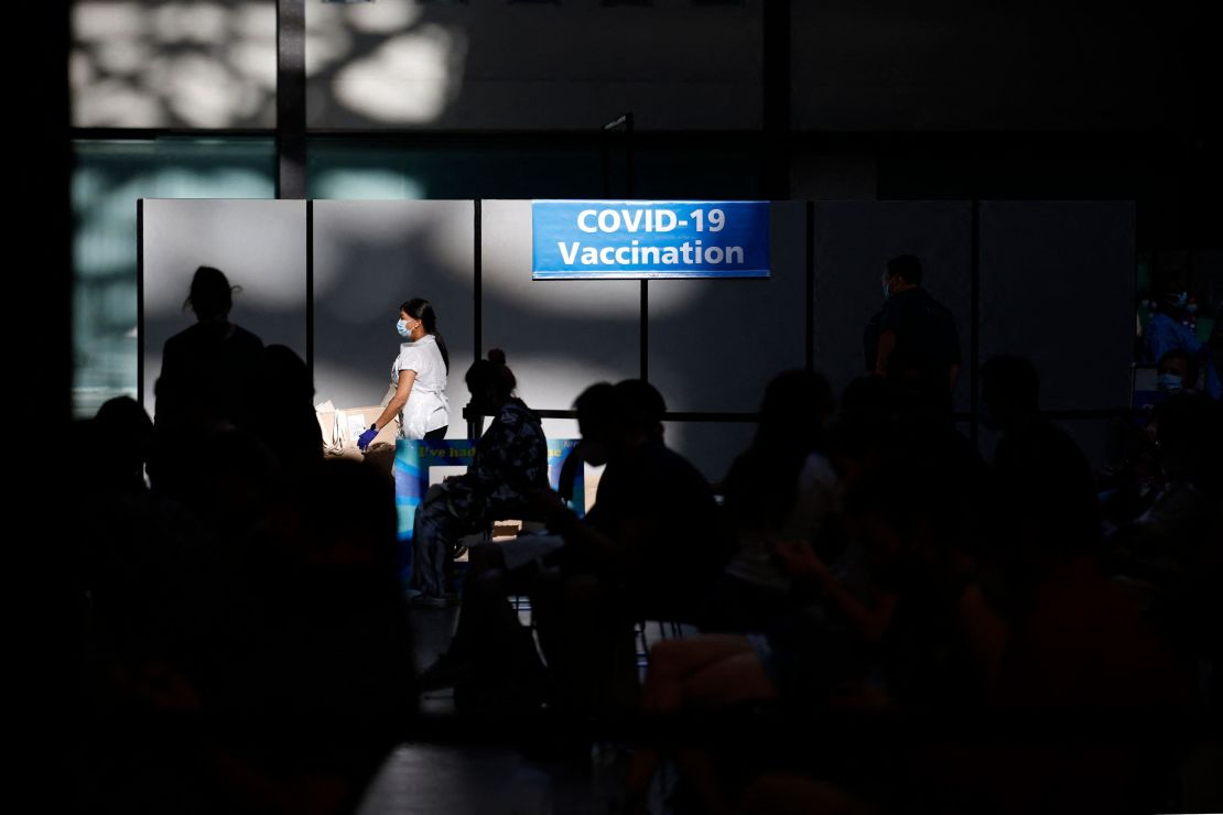 People wait at a temporary Covid-19 vaccine center in London, England. The United Kingdom, United States and countries in the European Union have said they may soon start rolling out booster shots.