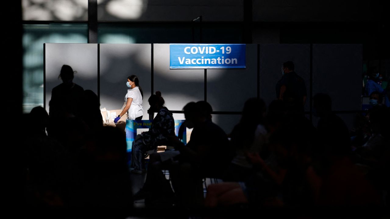 People wait at a temporary Covid-19 vaccine center in London, England. The United Kingdom, United States and countries in the European Union have said they may soon start rolling out booster shots.