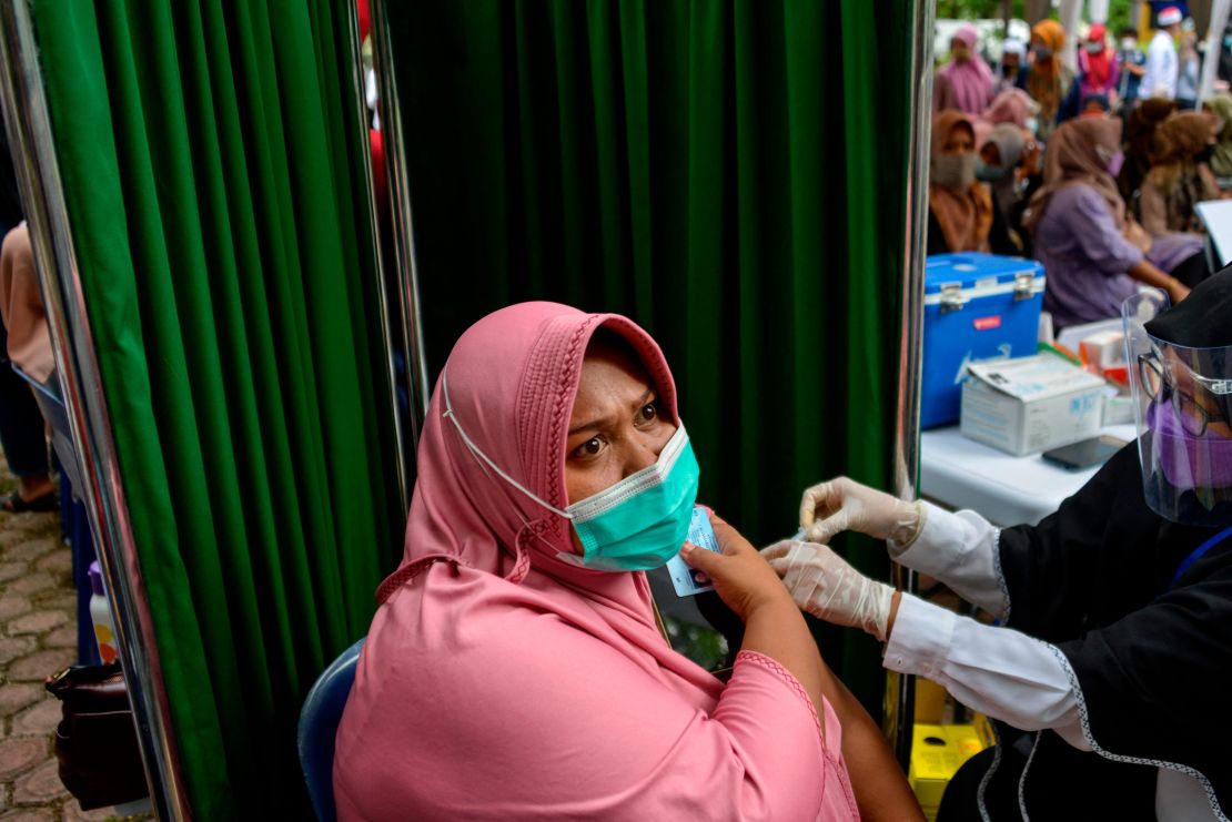 A woman receives a Sinovac vaccine in Banda Aceh, Indonesia. With less than 8% of its population fully vaccinated, Indonesia has overtaken India as Asia's new covid epicenter.