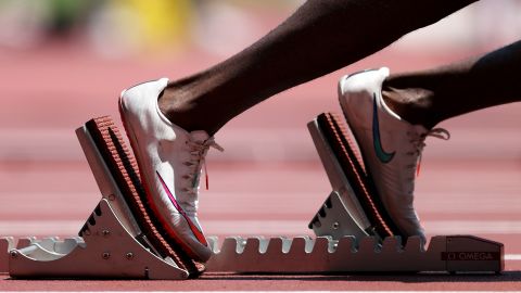 A runner takes to the starting blocks during the men's 400m heats at the Tokyo Olympics.