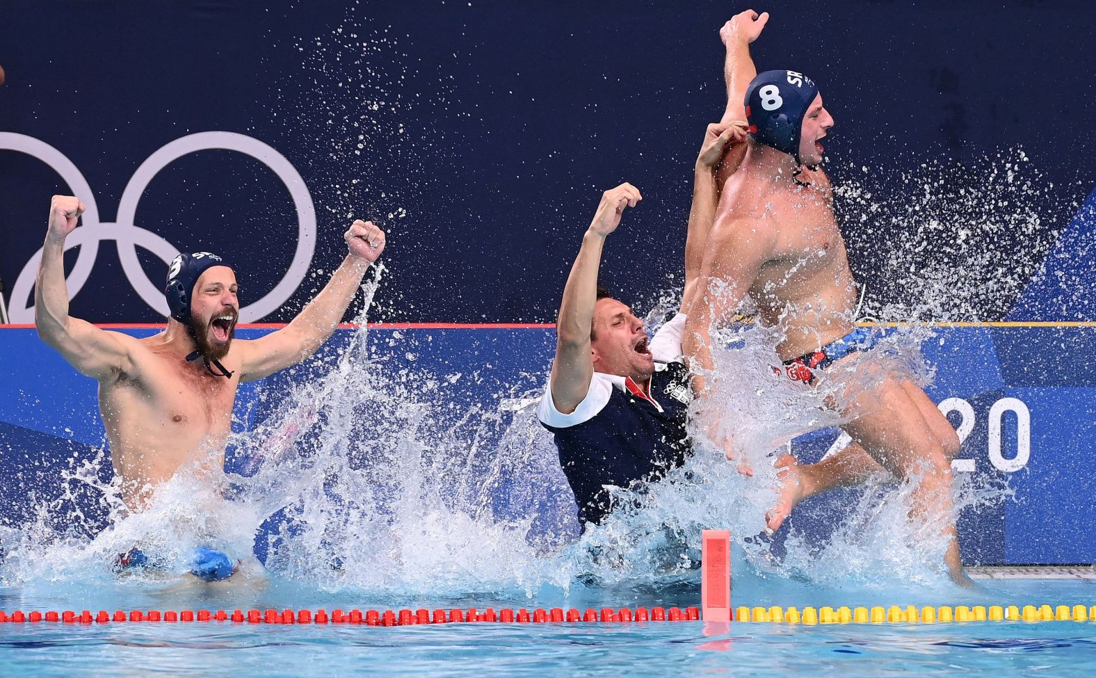 Serbia's Nikola Dedović, Vladimir Vujasinović and Milan Aleksić jump into the pool as they celebrate winning <a href="https://www.cnn.com/world/live-news/tokyo-2020-olympics-08-08-21-spt/h_a15625c29c75324d0b2fcf55f37f79ac" target="_blank">the water polo final against Greece </a>on August 8. Serbia won the match 13-10.