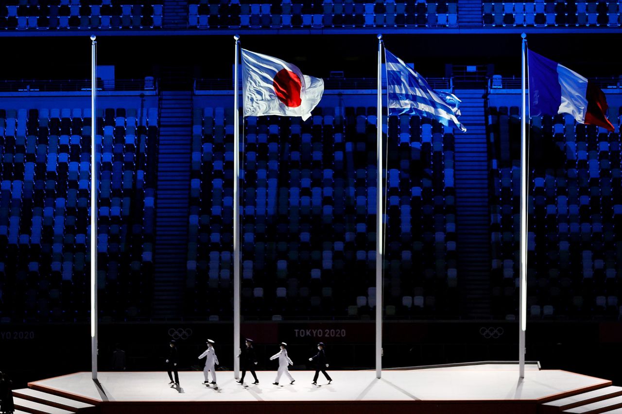 The national flags of Japan, Greece and France fly during the closing ceremony. Greece is the birthplace of the Olympic Games. France will host the 2024 Summer Olympics.