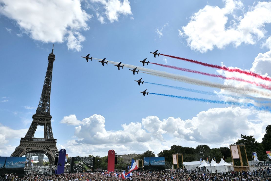 The French Air Force's aerobatic team -- 'Patrouille de France' -- flies over the fan village of The Trocadero set in front of The Eiffel Tower on August 8, 2021.