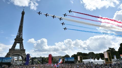The French Air Force's aerobatic team -- 'Patrouille de France' -- flies over the fan village of The Trocadero set in front of The Eiffel Tower on August 8, 2021.