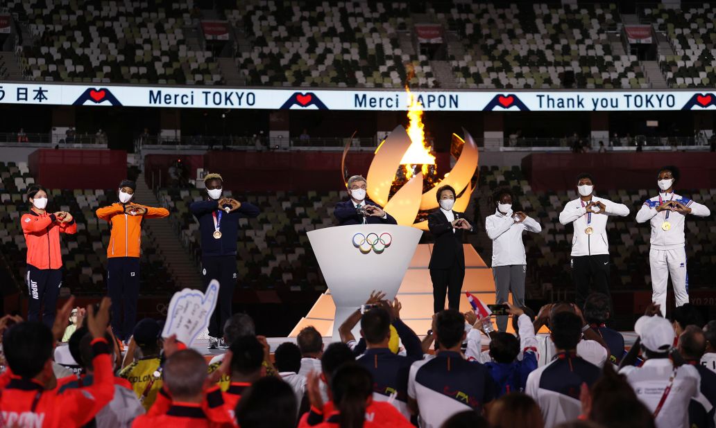 Thomas Bach, the president of the International Olympic Committee, makes a heart gesture as he delivers a speech at the closing ceremony. In his speech, Bach thanked the athletes and the Japanese people for their hard work and sacrifices in staging the most logistically challenging Olympic Games in history. "We did it together," he said.