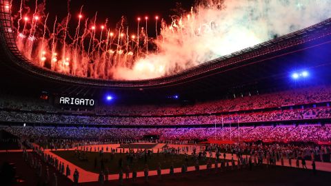 Fireworks explode over Tokyo's National Stadium at the end of the Olympics' closing ceremony on Sunday, August 8. The word "arigato," seen at left, means thank you in Japanese.