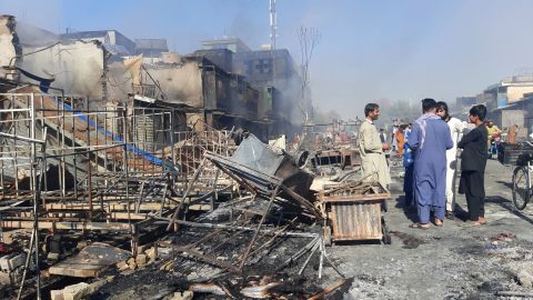 Afghans inspect damaged shops after fighting between Taliban and Afghan security forces in Kunduz city, northern Afghanistan, Sunday, August 8, 2021.