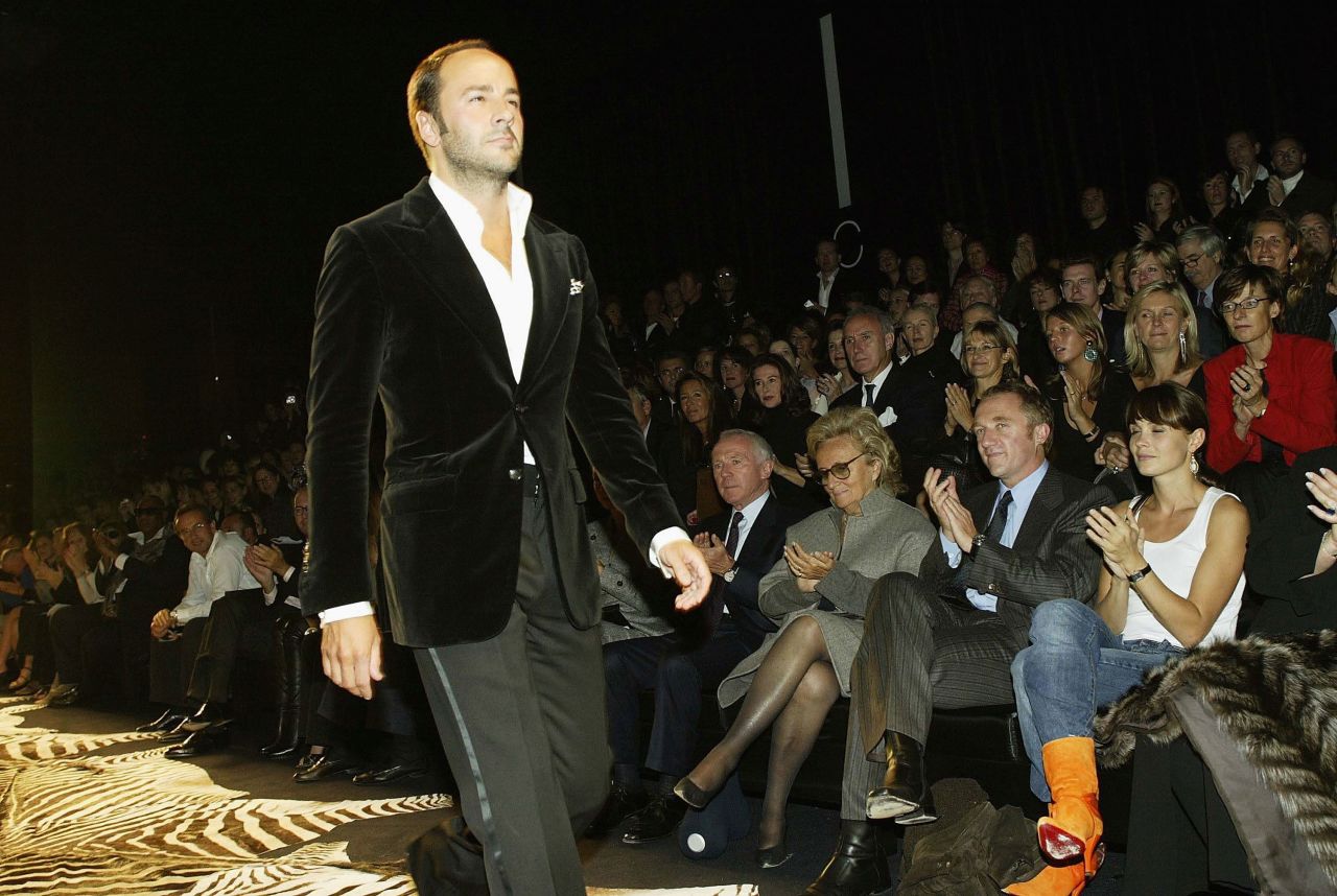 Tom Ford is applauded as he walks down a runway in 2003. At the time, Ford was creative director of both Gucci and Yves Saint Laurent.