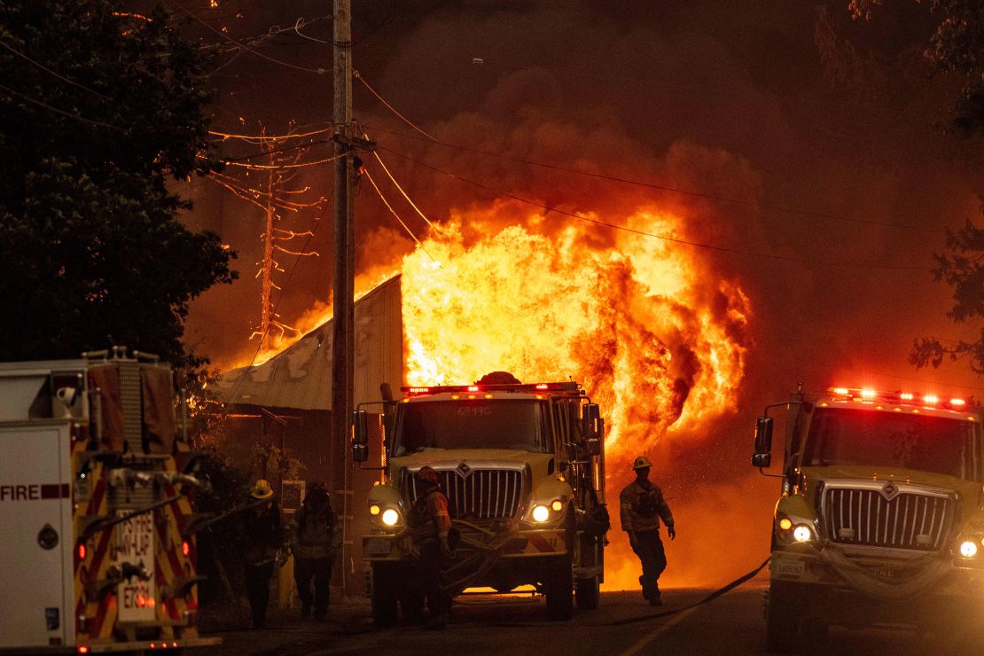 Flames consume a home as firefighters attempt to stop the spread of the Dixie fire in Greenville, California on August 4. The IPCC says it is 'unequivocal' that humans are causing climate change. 