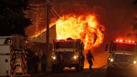 Flames consume a home as firefighters attempt to stop the spread of the Dixie fire in Greenville, California on August 4. The IPCC says it is 'unequivocal' that humans are causing climate change. 