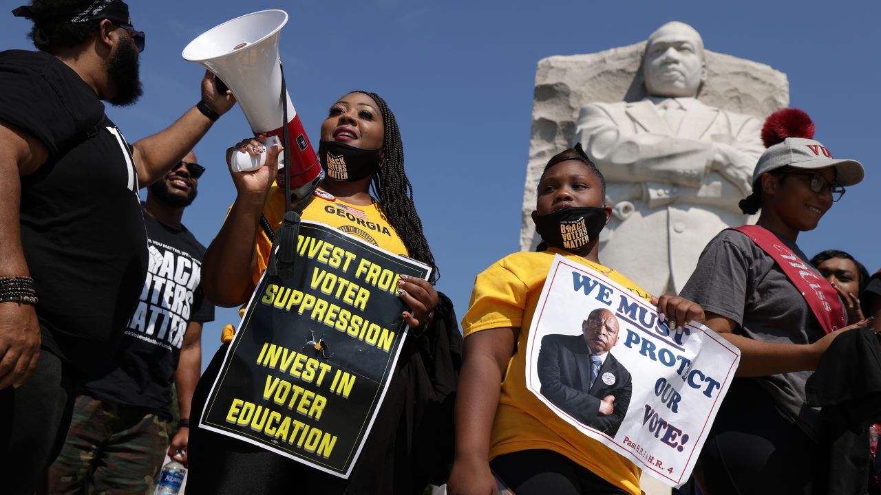 Shenita Binns holds a bullhorn as her daughter Ysrael Binns stands next to her during a "Freedom Friday March" protest at Martin Luther King, Jr. Memorial in Washington, DC, last week.
