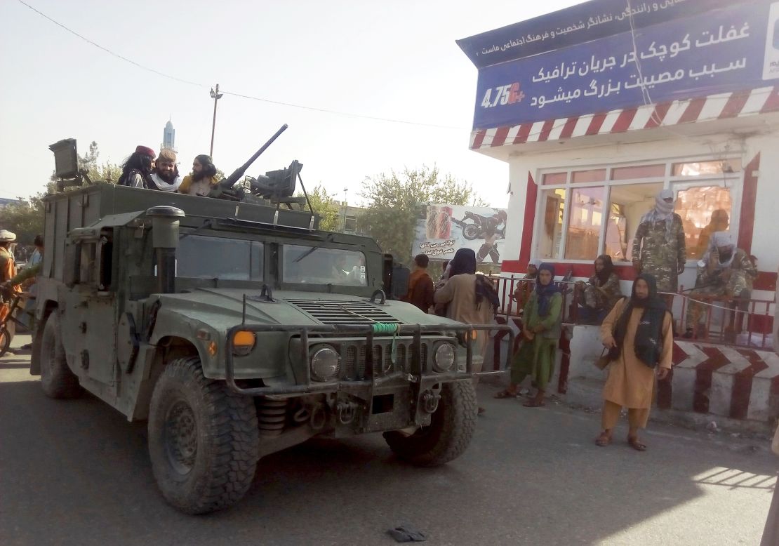 Taliban fighters stand guard at a checkpoint in Kunduz city, northern Afghanistan, on Monday.