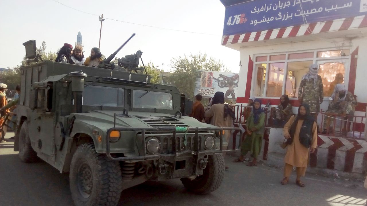 Taliban fighters stand guard at a checkpoint in Kunduz city, northern Afghanistan, on Monday.