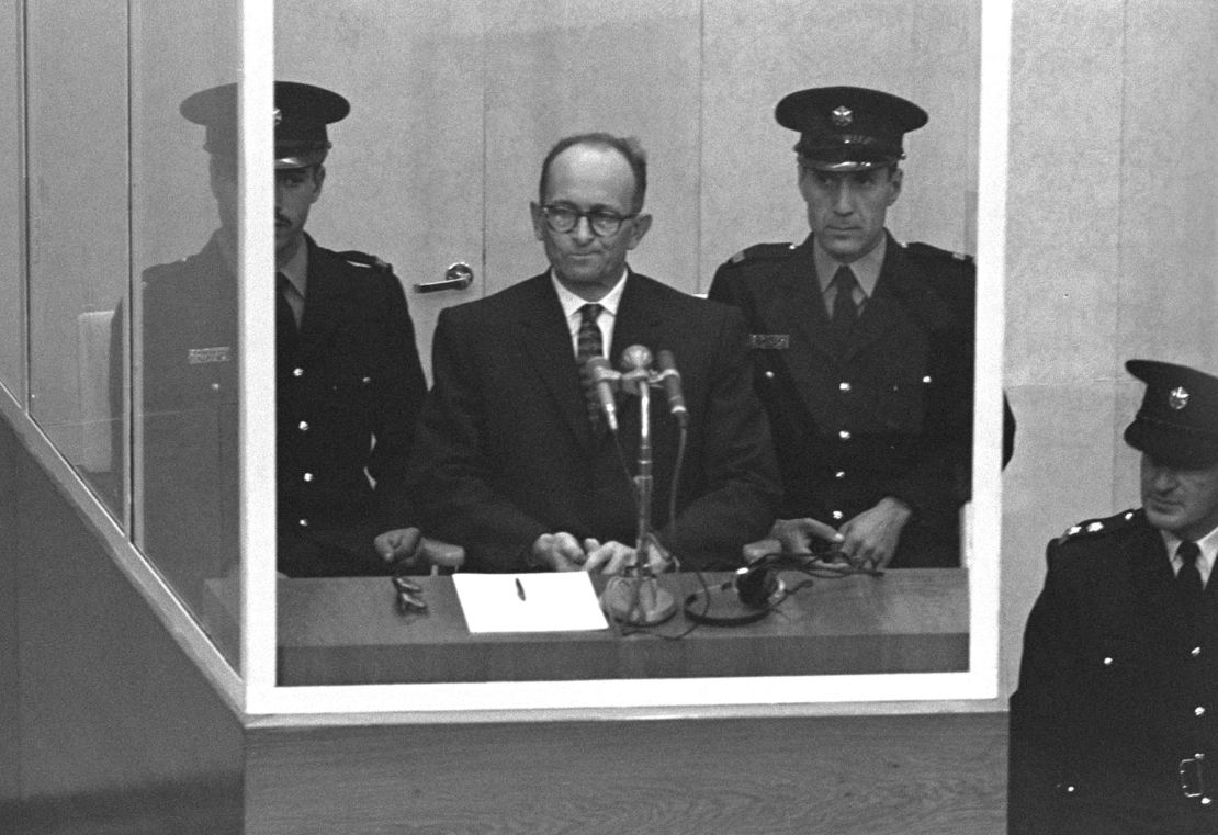 Nazi Adolf Eichmann stands in a protective glass booth flanked by Israeli police during his trial April 5, 1961 in Jerusalem.