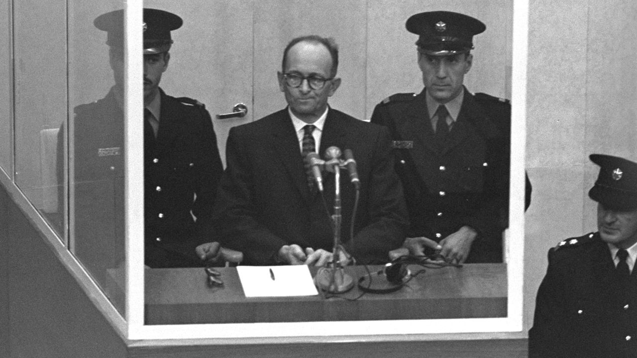 Nazi Adolf Eichmann stands in a protective glass booth flanked by Israeli police during his trial April 5, 1961 in Jerusalem.
