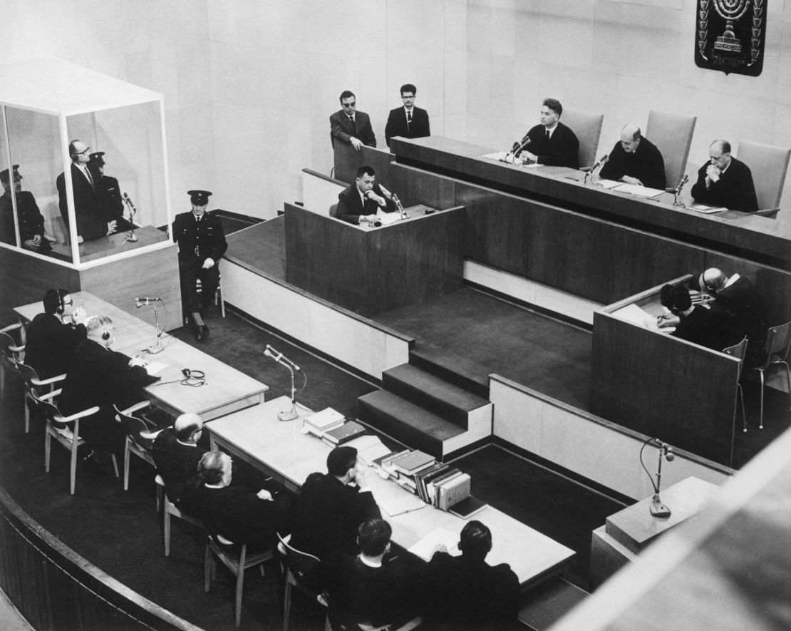 Adolf Eichmann listens in the prisoner's dock at the left, as presiding Judge Moishe Landau gives the verdict at the conclusion of his trial. 